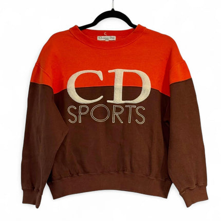 Vintage 1990's Christian Dior CD Sports sweatshirt with raised CD letters in terry towel fabric, and SPORTS outline text letters written underneath orange and brown color. The color is split, top half of sweatshirt is orange while bottom half of sweatshirt is brown. Imported from Japan so sizing is smaller. No holes, rips, or stains.