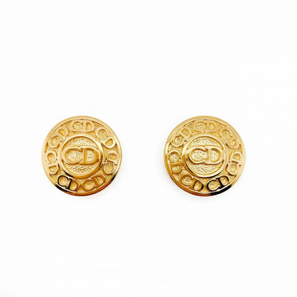 Round Christian Dior gold earrings with CD letters repeated going around outer circle and the letters CD also inside a center circle