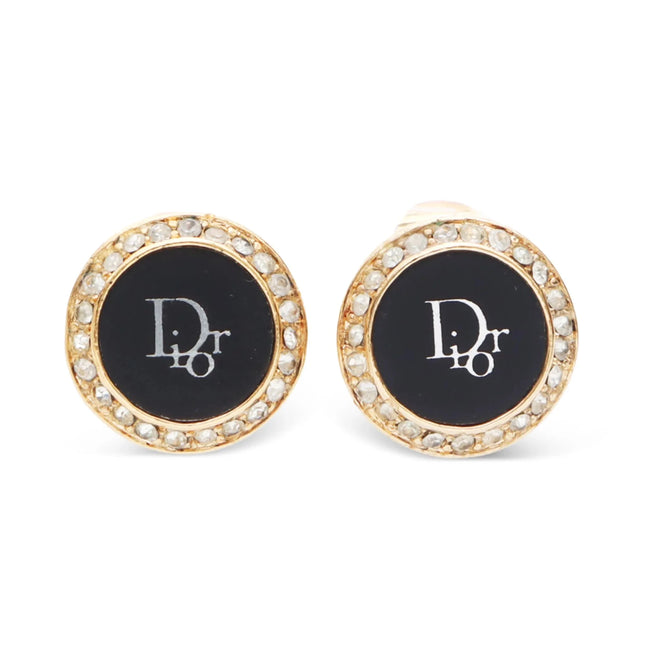 Christian Dior round earrings with rhinestones around outer circle of earring and inner circle is black filled with white Dior logo in center