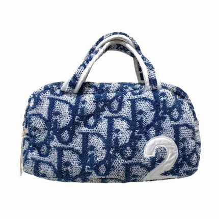 Blue and white Dior trotter terry towel cloth bag with repeating Dior monogram logo going around bag and the number 2 on the bottom right hand corner of the front of the bag