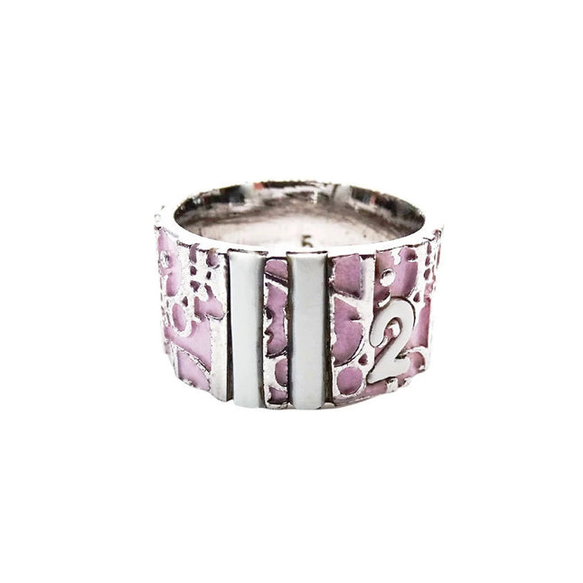 Christian Dior trotter ring with Dior monogram around ring and the number 2 in white and pink enamel inlay.