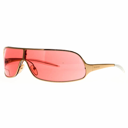 Gucci sunglasses with a gold metal frame and pink colored lenses that have a sense of elegance. The Gucci logo is etched into the metal arms of the stems.