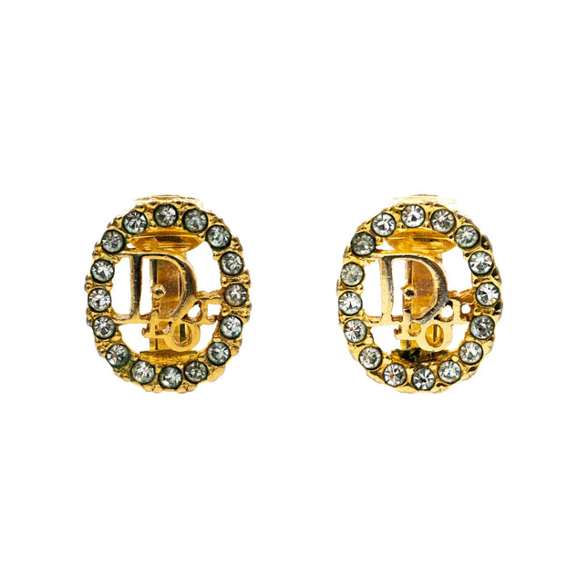 Oval shaped Christian Dior gold clip on earrings with Dior logo in center and crystals surrounding