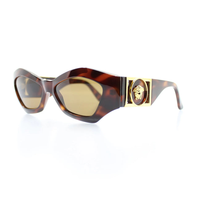 Versace cat eye shaped sunglasses in brown tortoise shell color with gold accents on the sides and the gold medusa head motif logo in center inside a circle